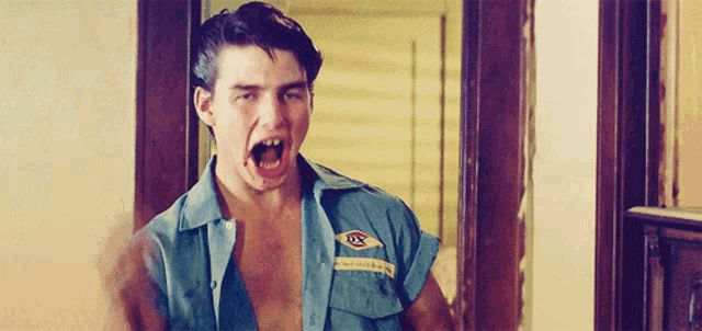 a man wearing a shirt that says dx on it is making a funny face