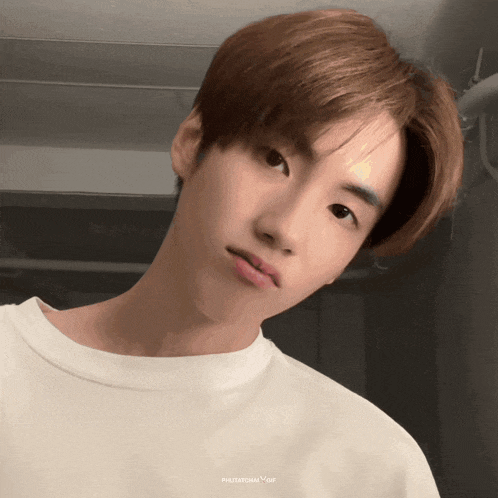 a close up of a young man 's face with the words photochan gif below it