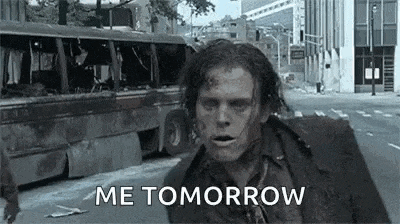 a zombie is walking down a city street with the words `` me tomorrow '' .