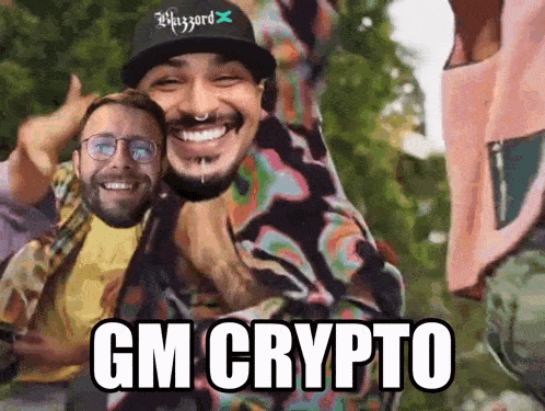 two men are laughing and one has the word gm on his hat