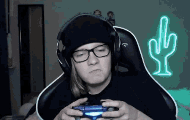 a person wearing headphones and glasses is holding a controller