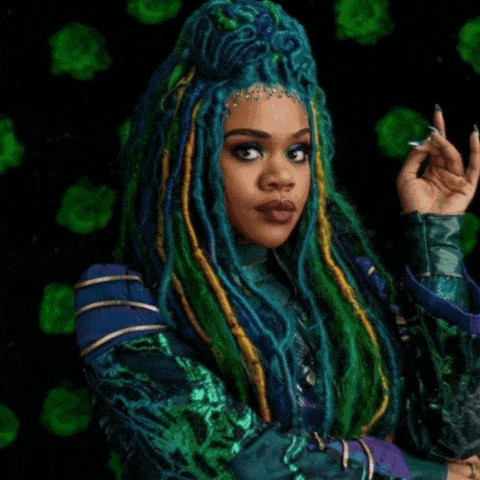 a woman with dreadlocks and blue hair is standing in front of a purple and red background