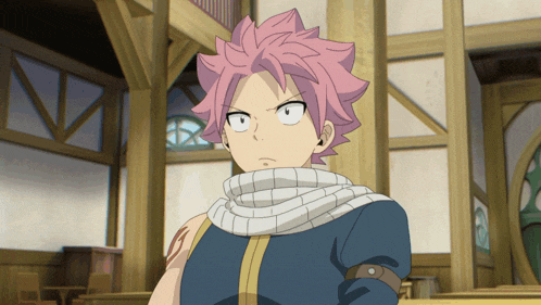 a man with pink hair and a scarf around his neck