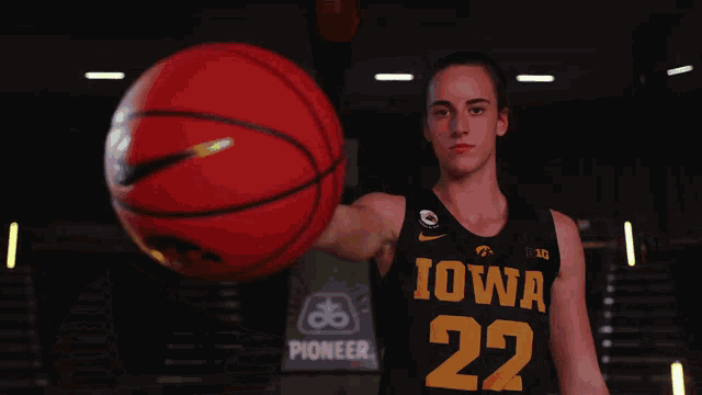 a basketball player for the iowa team holds a basketball