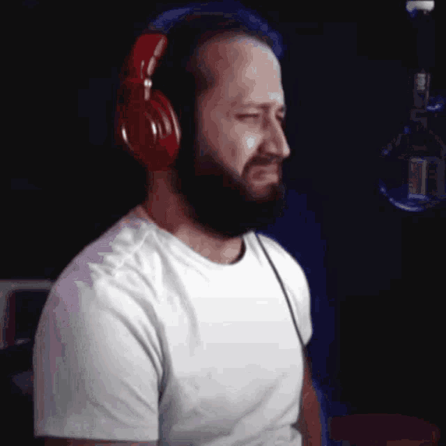a man with a beard wearing red headphones
