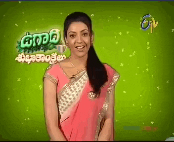 a woman in a pink and white saree stands in front of a green background with the word tv on it