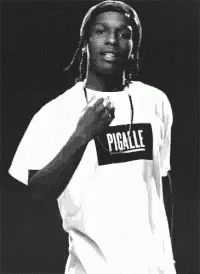 a black and white photo of a man wearing a pigalle t-shirt .