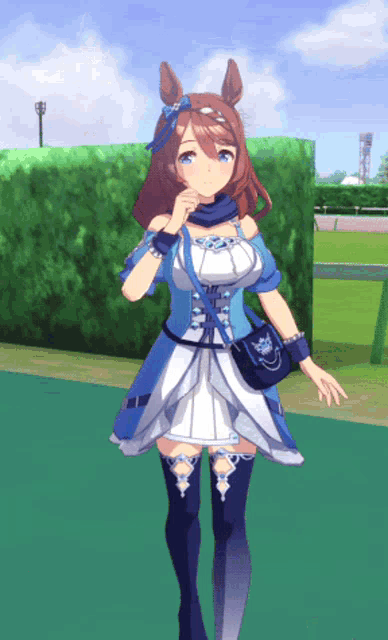 a girl in a blue and white dress is standing on a green carpet