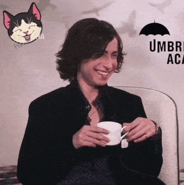 a man is holding a cup of coffee in front of an umbrella academy sign