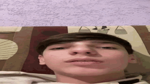 a close up of a person 's face against a purple background
