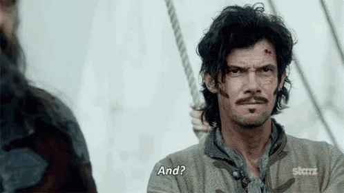 a man with a beard and mustache is talking to another man on a boat and says `` and ? ''