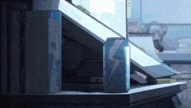 a blue can with a lightning bolt on it sits on a table