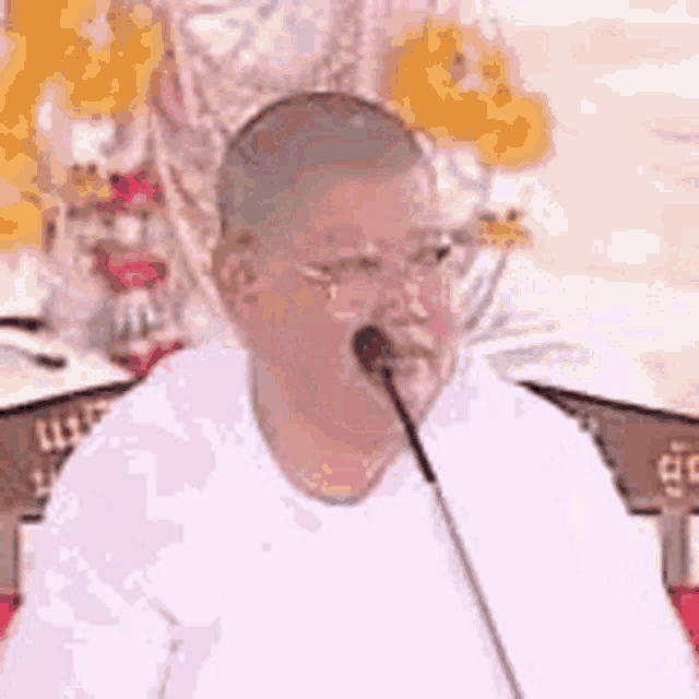 a man is sitting in front of a microphone .
