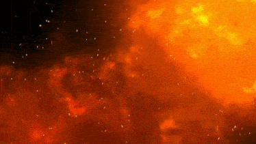 a large fire with sparks flying in the air