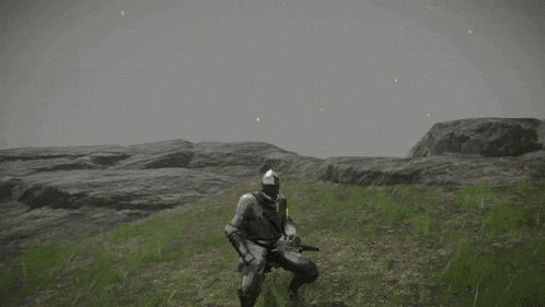 a man in armor is kneeling in a field