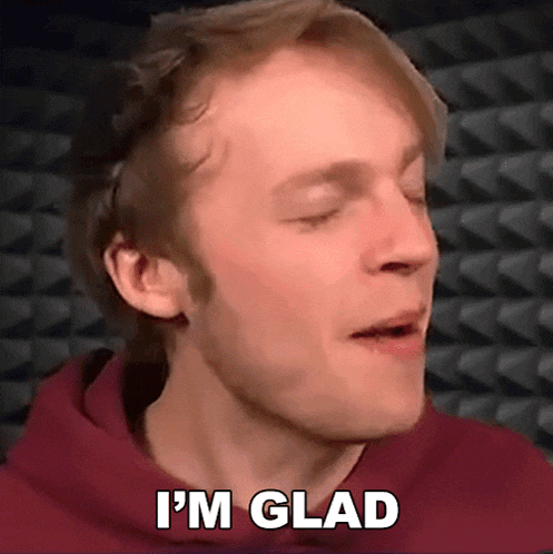 a man in a red hoodie is making a face and saying i 'm glad .