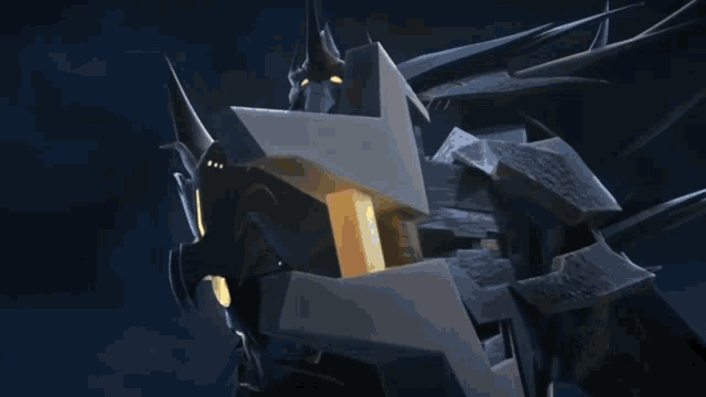 a close up of a robot with a yellow light coming out of its mouth