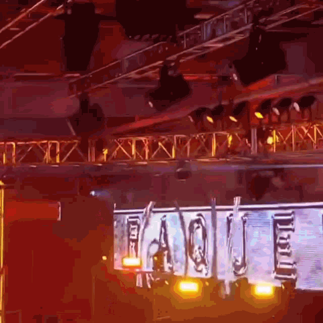 a stage with a large screen that says ' faq ' on it