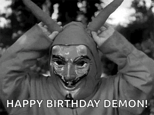 a black and white photo of a person wearing a mask with the words happy birthday demon below it