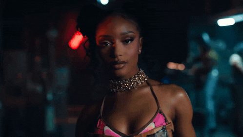 a close up of a woman wearing a choker necklace