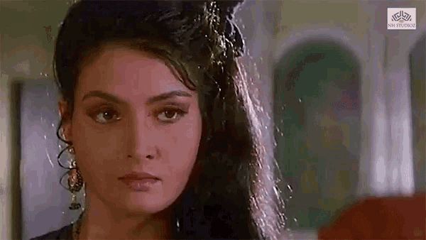 a close up of a woman 's face with long hair looking at the camera .