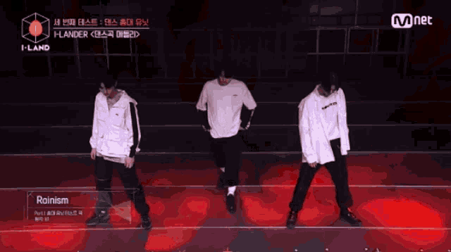 a group of men are dancing in front of a mnet sign
