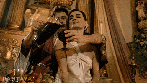 a man pours a glass of wine into a woman 's hand with pantaya written on the bottom right