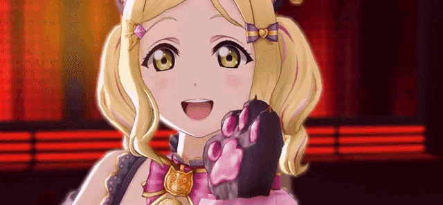 a girl in a cat costume is holding a cat paw .