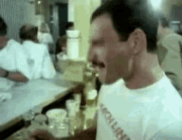 a man wearing a white shirt that says rock n ' roll