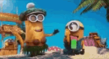 a couple of minions are standing on a beach .
