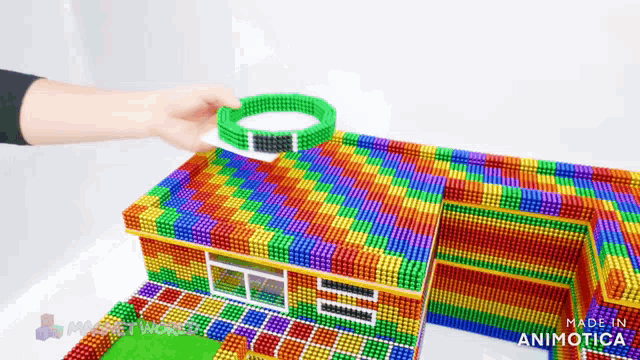 a colorful house made out of magnets with the words made in animatica on the bottom right