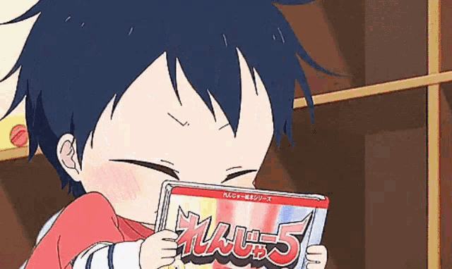 a little boy is reading a book with the number 5 on the cover