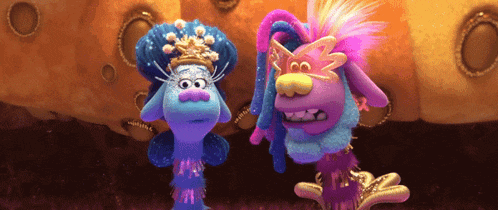 a couple of trolls standing next to each other with one wearing a crown