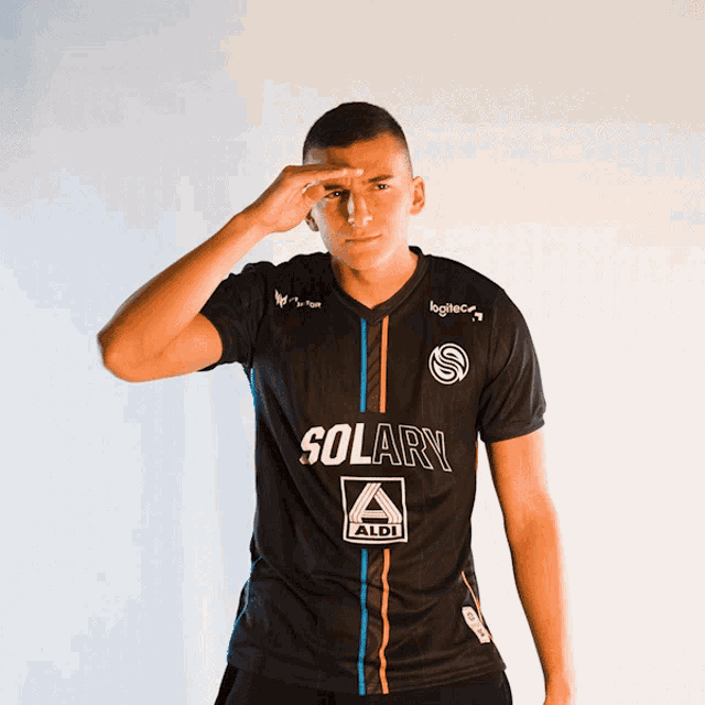 a man wearing a black shirt with solary written on it