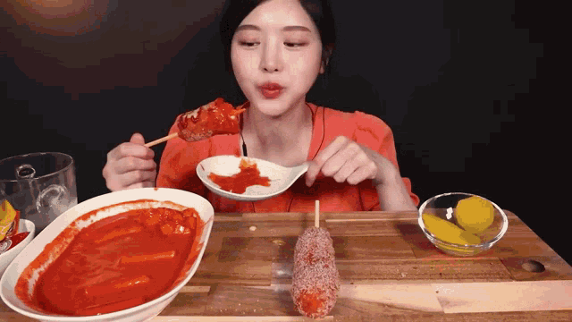a woman is sitting at a table eating food