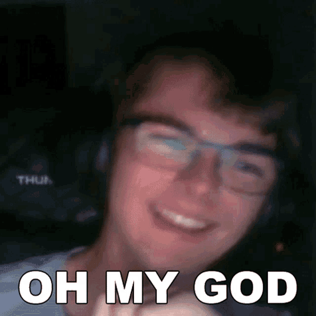 a man wearing glasses and headphones is smiling with the words oh my god above him