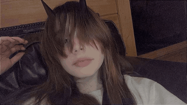 a girl with long hair and horns on her head