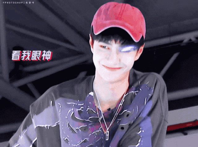 a young man wearing a red baseball cap and a purple shirt
