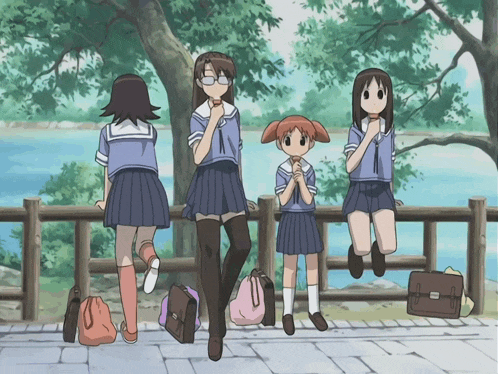 a group of girls in school uniforms standing on a fence