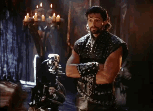 a man with his arms crossed says " oh " in a room with candles