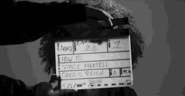 a person holding a clapper board that says how to vince martell greg s. reich