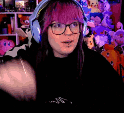 a woman with purple hair and glasses is wearing blue headphones