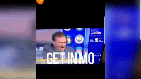 a man on a television screen with the words get in mo