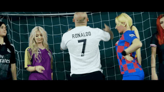 a man in a ronaldo 7 jersey stands in front of a soccer net