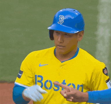 a baseball player wearing a yellow jersey with boston on it