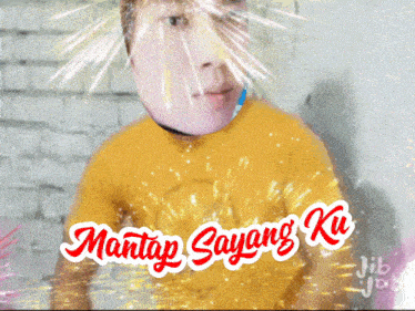 a man in a yellow shirt with the words mantap sayang ku on the bottom