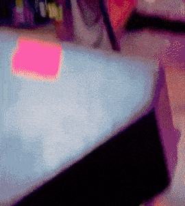 a pink sticky note on a bed that says ' i love you ' on it