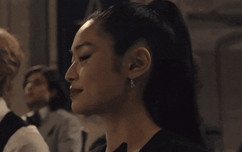 a close up of a woman 's face with earrings on