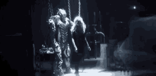 a couple of people standing in a dark room with the word cw on the bottom