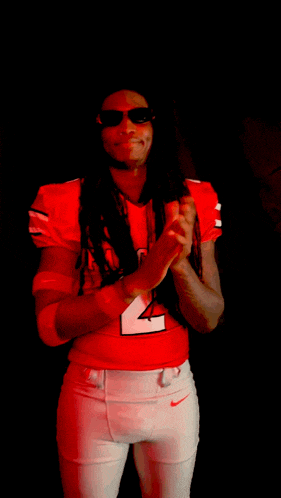 a man wearing a red jersey that says 2 on it